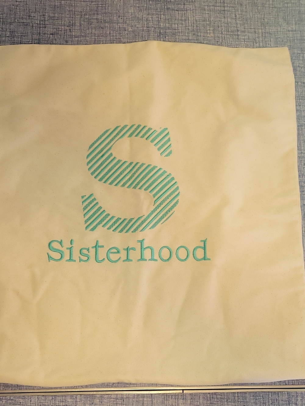 SisterHood Cream Canvas Pillow Cover w/zipper. Teal Embroidered Logo